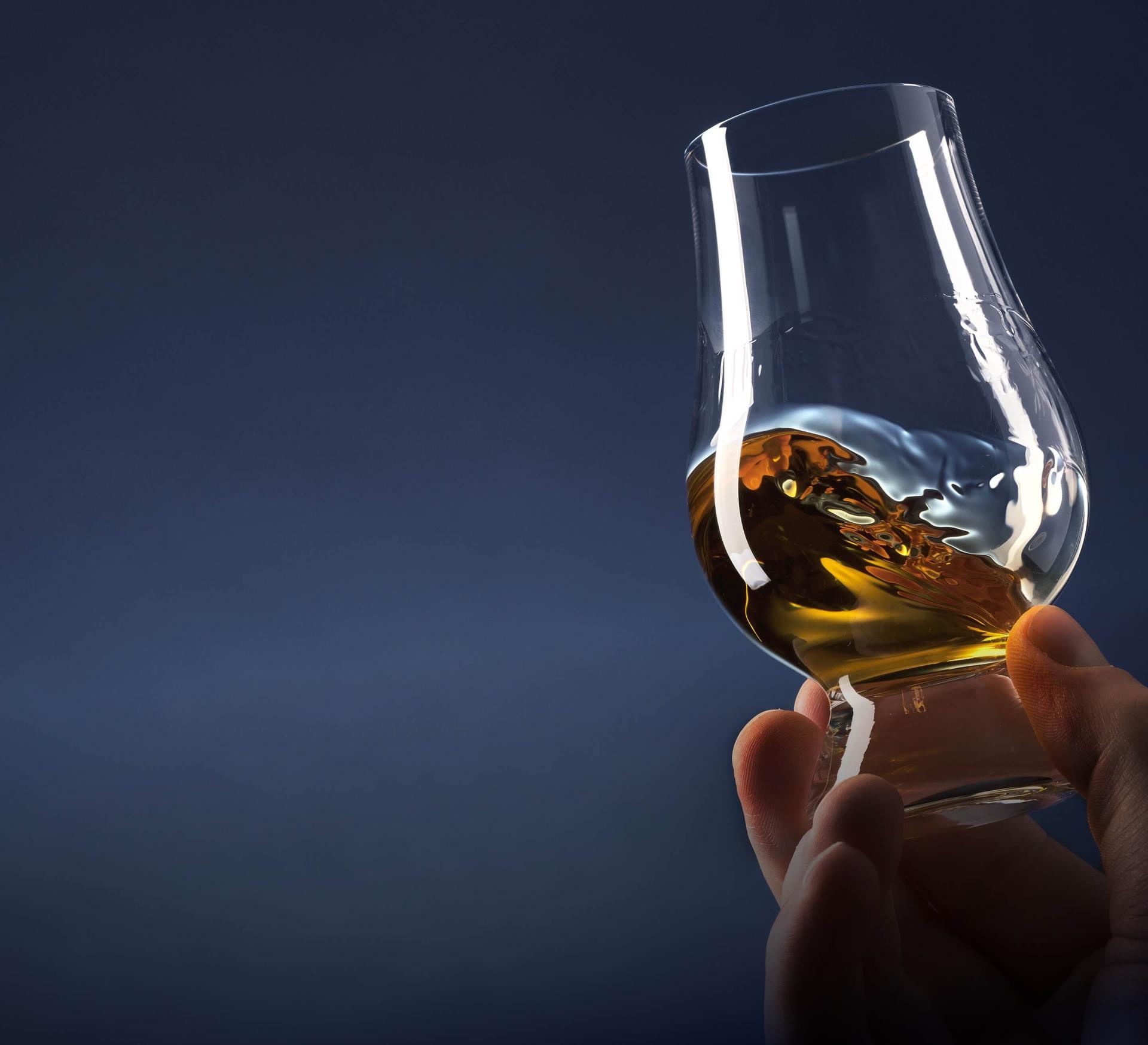 Glass of whiskey on hand